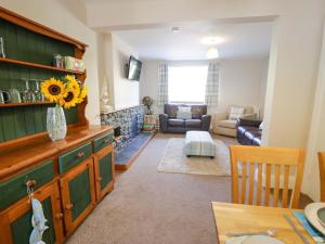 a living room with a couch and a table at Bryn Hyfryd in Conwy