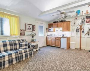 a living room with a couch and a kitchen at Quiet Getaway with Queen Bed & Wi-Fi in Clarks Summit