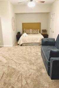 a bedroom with a bed and a couch at Apple Valley Chateau Mountain Getaway in Hendersonville