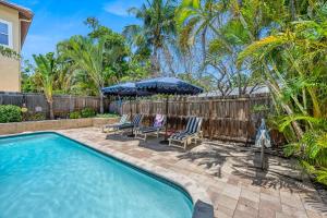 a swimming pool with two chairs and an umbrella at Siesta Dolce - 3750 in Siesta Key