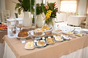 a table with a buffet of food on it at Hotel Presidente in Imperatriz