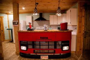 a kitchen with a large red island in the middle at Southern Comfort Retreat with a private hot tub in Scottsboro