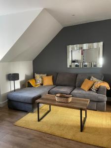 a living room with a couch and a table at Foundry Street Apartment 3 - Dunfermline City Centre in Dunfermline