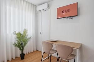 a dining room with a table and two chairs at GuestReady - Tutti Frutti Studios in Porto