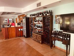 a room filled with lots of bottles of wine at Babos Holidays in Ammoudia