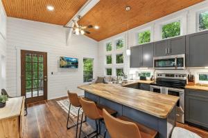 a kitchen with a large island with a wooden ceiling at Hot Tub, Secluded Hickory Tiny Home in Menlo! in Menlo