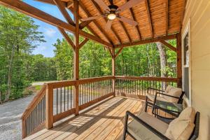 a screened porch with chairs and a ceiling fan at Hot Tub, Secluded Hickory Tiny Home in Menlo! in Menlo