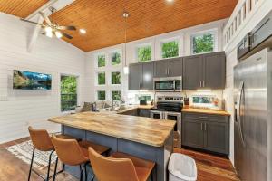 a kitchen with gray cabinets and a wooden ceiling at The Hickory Tiny Home in Menlo in Menlo +25 photos
