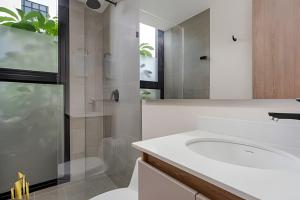 a bathroom with a toilet and a sink and a shower at Solei Loft 401 - Elegance & Comfort /AC in Poblado in El Poblado +12 photos