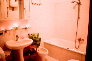 a bathroom with a sink and a tub and a toilet at Al Delfino Blu in Aurelia