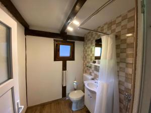 a bathroom with a toilet and a sink and a window at UNA Dream in Bihać