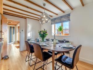 a dining room with a table and chairs at Landers Mews in Trunch