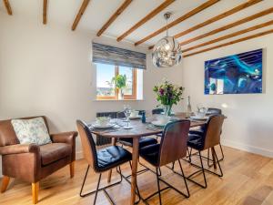 a dining room with a table and chairs at Landers Mews in Trunch