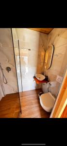 a bathroom with two sinks and a toilet and a shower at Guest house Lepushe in Rrëshen