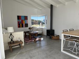 a living room with a couch and a table at Olasanta - Casa en Chapa zona Cruz del Sur para 4 PAX con vista al mar - Hola Sur in Chapadmalal