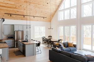 a kitchen and living room with a couch and a table at Hidden Arbor House - newly renovated retreat in Berrien Springs