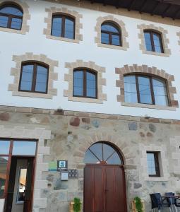 a building with several windows and a door at El Alba in La Lastra