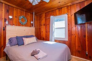 a bedroom with a bed in a wooden wall at New renovated bathroom & new roof - Lake Huron 5 in Lincoln Junction