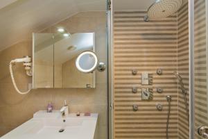a bathroom with a sink and a shower with a mirror at Dubrovnik Luxury Residence – L’Orangerie in Dubrovnik