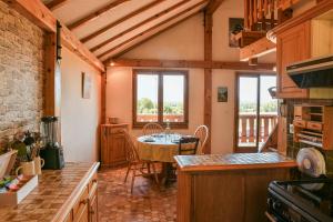 a kitchen with a table and a dining room at La Lauzière - Chalet Parking Jardin in Grésy-sur-Isère +14 photos