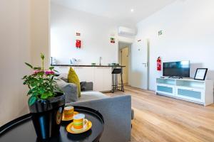 a living room with a couch and a table at Casa Ribeiro in Funchal