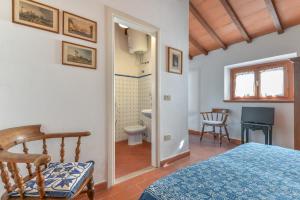 a bedroom with a bed and a bathroom at Beach Villa with Private Garden in Marina di Campo in Marina di Campo +37 photos