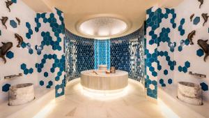 a bathroom with a round tub and blue and white tiles at Crowne Plaza Florya Istanbul by IHG in Istanbul