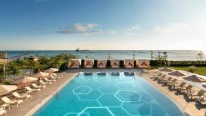 a swimming pool with lounge chairs and the ocean at Crowne Plaza Florya Istanbul by IHG in Istanbul