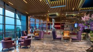 a lobby with purple chairs and tables and windows at Crowne Plaza Florya Istanbul by IHG in Istanbul