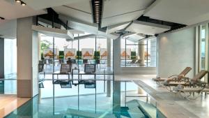 a lobby with a pool and chairs and glass floors at Crowne Plaza Florya Istanbul by IHG in Istanbul +37 photos