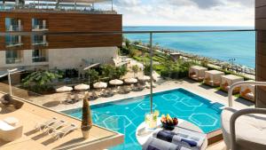 a view of the pool and ocean from the balcony of a hotel at Crowne Plaza Florya Istanbul by IHG in Istanbul