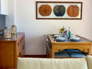 a dining room with a table with plates on it at Casa Loto in Estepona