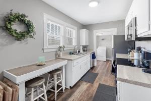 a kitchen with white cabinets and a counter top at Red Bud in Chattanooga