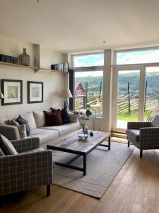 a living room with a couch and a table at Stay in central Geilo, 3 bedrooms, linen and towels included in Geilo