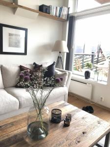 a living room with a vase of flowers on a table at Stay in central Geilo, 3 bedrooms, linen and towels included in Geilo
