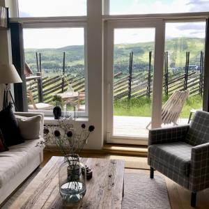 a living room with a couch and a table at Stay in central Geilo, 3 bedrooms, linen and towels included in Geilo