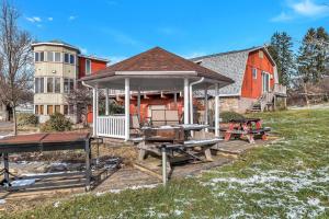 a gazebo in front of a red house at Quiet Getaway with Queen Bed & Wi-Fi in Clarks Summit +9 photos