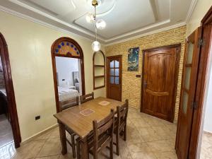 a dining room with a table and a mirror at Jb house in Chefchaouen