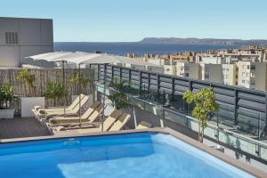 a swimming pool on the roof of a building at NH Alicante in Alicante