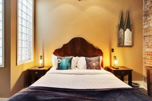 a bedroom with a large bed with two night stands at Chic Loft | Downtown | Front & Market in Wilmington