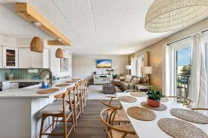 a kitchen and living room with tables and chairs at Ocean Front 3 Bedroom in North Wildwood