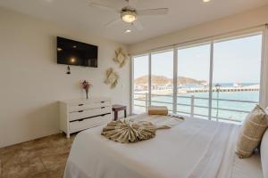 a bedroom with a large bed with a view of the ocean at La Playa Suites in Santa Cruz Huatulco