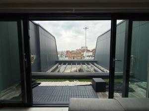 an open glass door of a building with a view at Modern Spacious Leeds Penthouse in Central Station