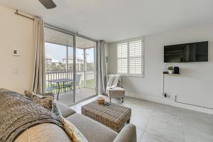 a living room with a couch and a tv at Walk to Public Beach Access Bonita Springs Gem! in Bonita Springs