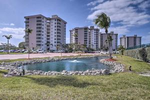 a pond in a park with buildings in the background at Walk to Public Beach Access Bonita Springs Gem! in Bonita Springs