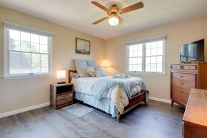 a bedroom with a bed and a ceiling fan at 11 Mi to Asheville Scenic Retreat with Game Room in Candler