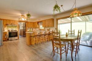 a kitchen with a table and chairs and a dining room at 11 Mi to Asheville Scenic Retreat with Game Room in Candler