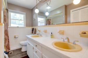 a bathroom with two sinks and a toilet at 11 Mi to Asheville Scenic Retreat with Game Room in Candler +26 photos