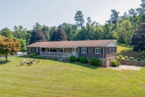a house with a large yard in front of it at 11 Mi to Asheville Scenic Retreat with Game Room in Candler