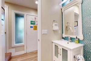 a bathroom with a sink and a mirror at On the Doorstep in Anaheim +20 photos